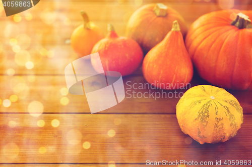 Image of close up of pumpkins on wooden table at home