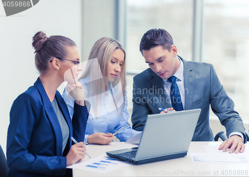 Image of business team with laptop having discussion