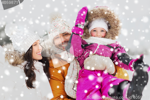 Image of happy family with child in winter clothes outdoors
