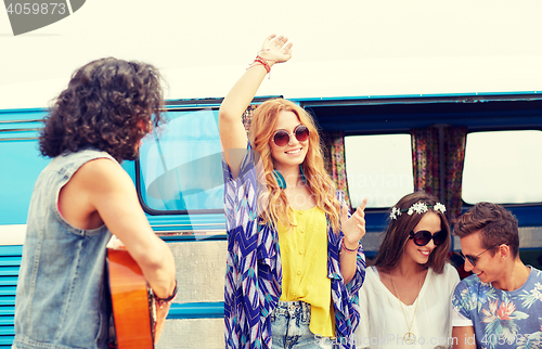 Image of happy hippie friends having fun over minivan car