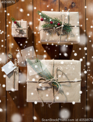 Image of close up of christmas gifts with fir brunch