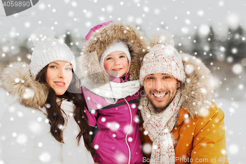 Image of happy family with child in winter clothes outdoors
