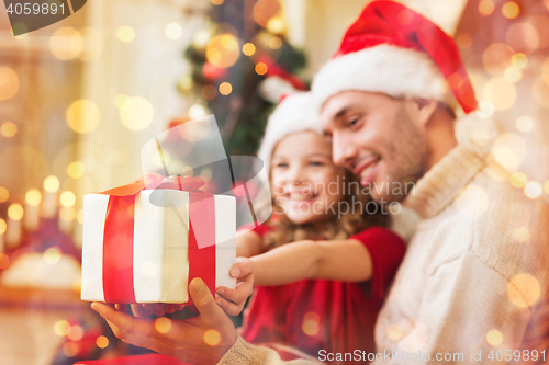 Image of close up of father and daughter with gift box