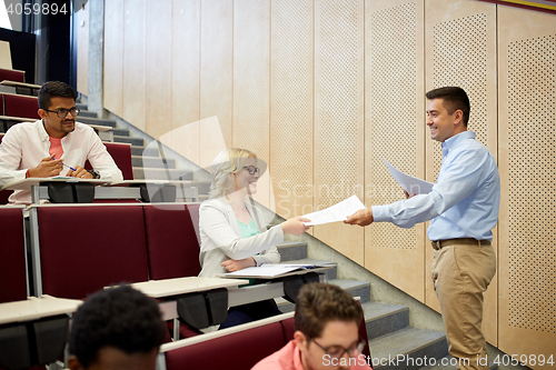 Image of teacher giving tests to students at lecture