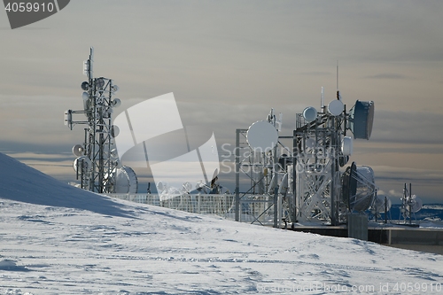 Image of Transmitter towers on a hill in winter