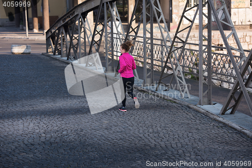 Image of sporty woman jogging on morning