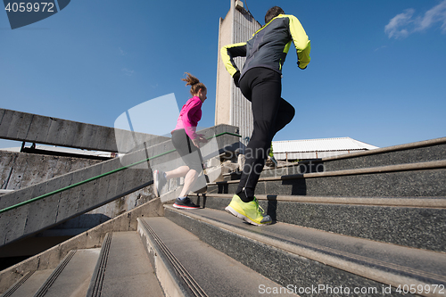 Image of young  couple jogging on steps