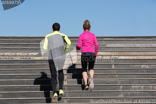 Image of young  couple jogging on steps