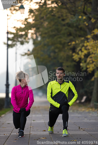 Image of couple warming up before jogging