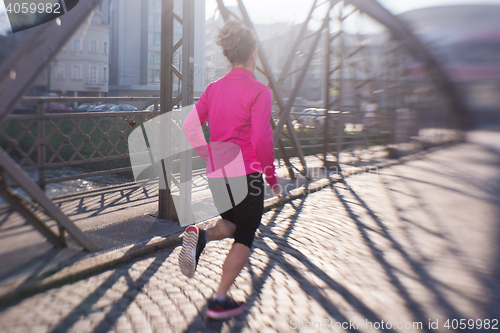 Image of sporty woman jogging on morning