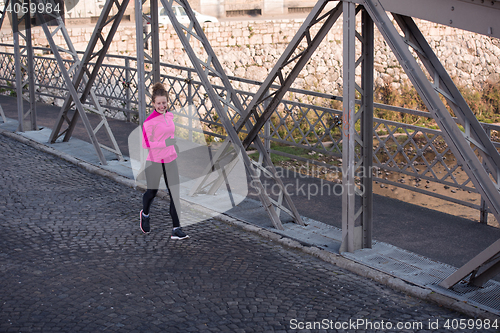 Image of sporty woman jogging on morning