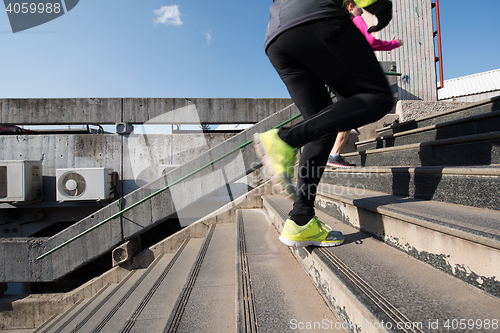 Image of young  couple jogging on steps