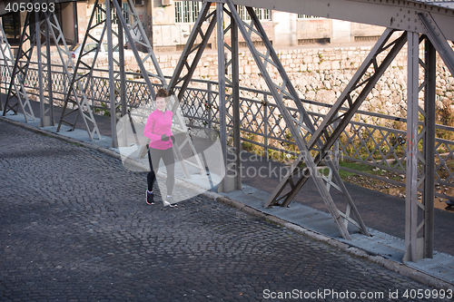 Image of sporty woman jogging on morning