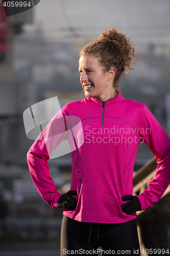 Image of woman  stretching before morning jogging