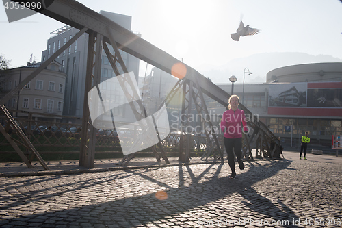 Image of sporty woman jogging on morning