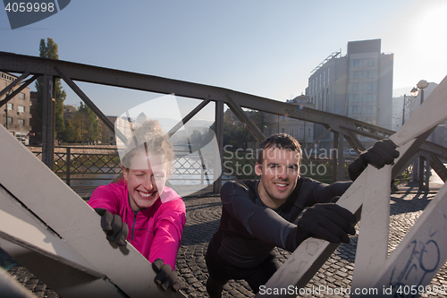 Image of couple warming up before jogging