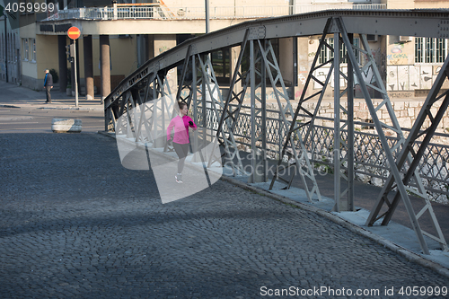 Image of sporty woman jogging on morning