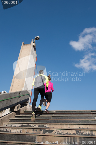 Image of young  couple jogging on steps