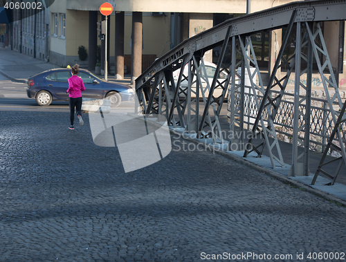 Image of sporty woman jogging on morning