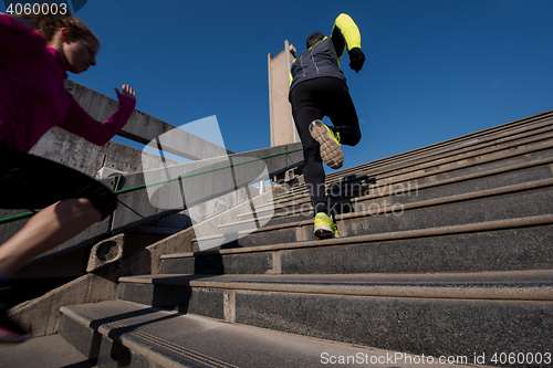 Image of young  couple jogging on steps