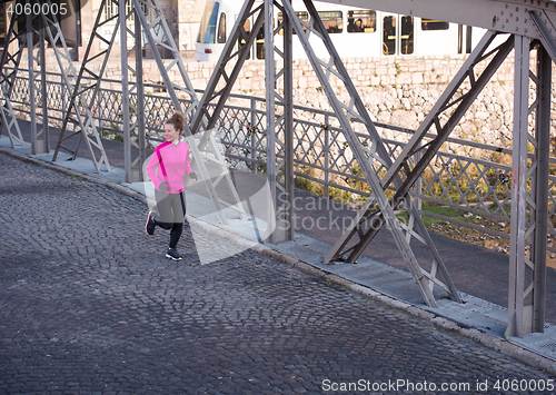 Image of sporty woman jogging on morning