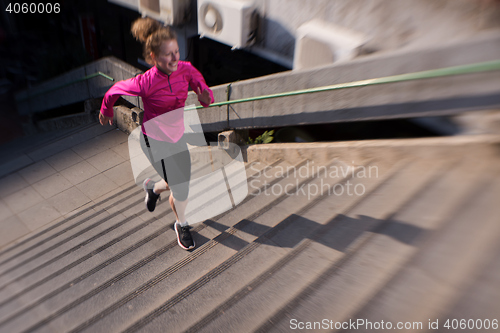 Image of woman jogging on  steps