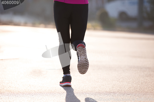 Image of sporty woman jogging on morning