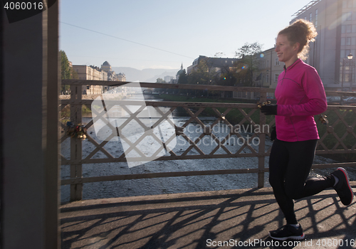 Image of sporty woman jogging on morning