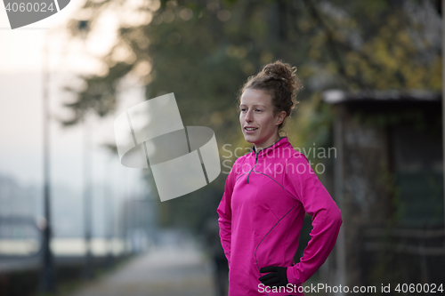 Image of woman  stretching before morning jogging