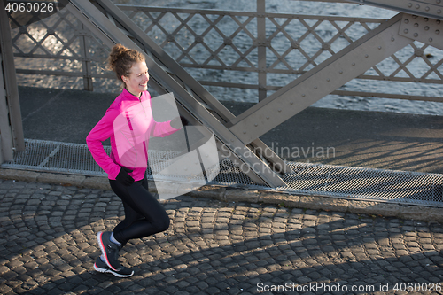 Image of sporty woman jogging on morning