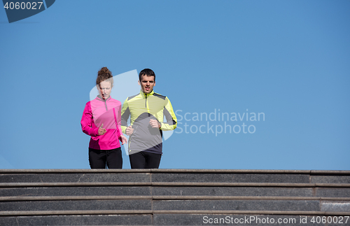 Image of young  couple jogging on steps