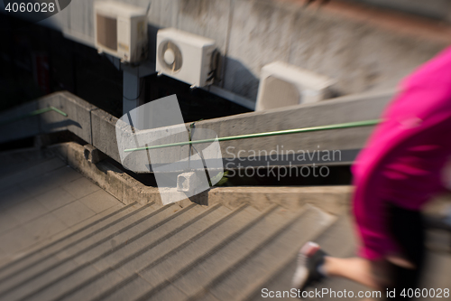 Image of woman jogging on  steps