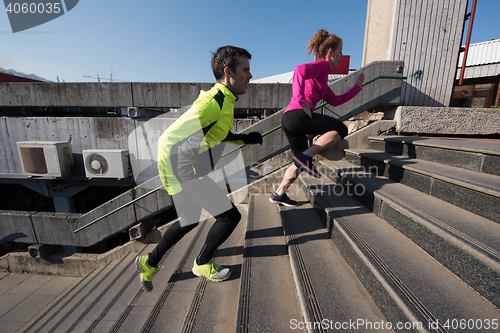 Image of young  couple jogging on steps