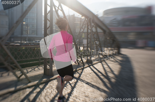 Image of sporty woman jogging on morning