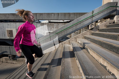 Image of woman jogging on  steps