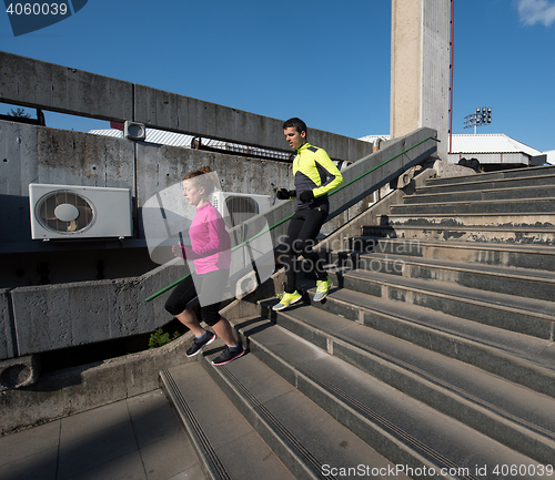 Image of young  couple jogging on steps