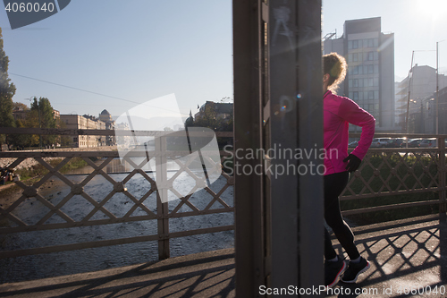 Image of sporty woman jogging on morning