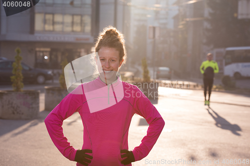 Image of woman  stretching before morning jogging