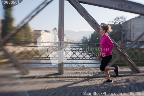 Image of woman  stretching before morning jogging