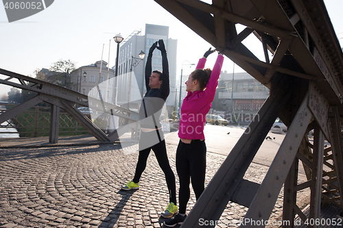 Image of couple warming up before jogging