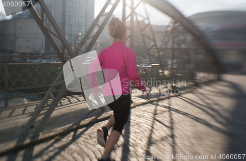 Image of sporty woman jogging on morning