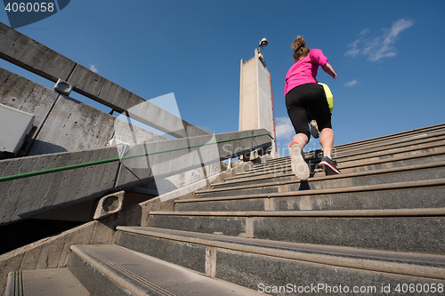 Image of woman jogging on  steps