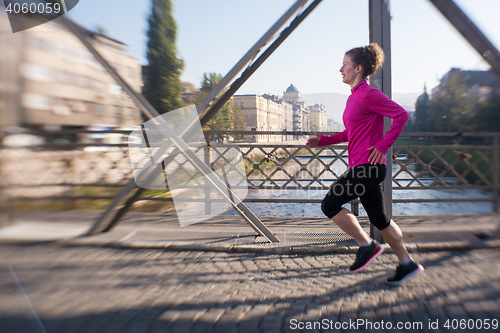 Image of sporty woman jogging on morning