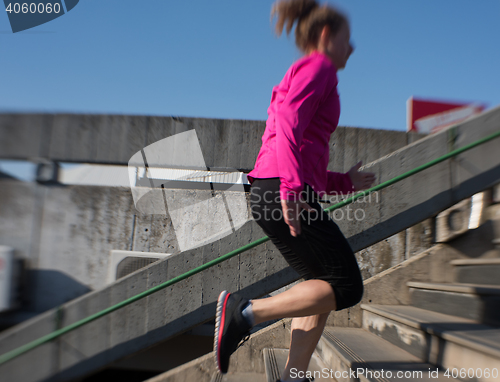 Image of woman jogging on  steps