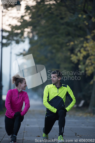 Image of couple warming up before jogging