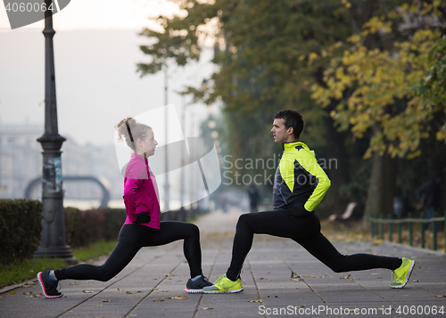 Image of couple warming up before jogging