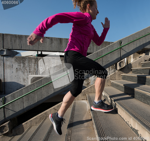 Image of woman jogging on  steps