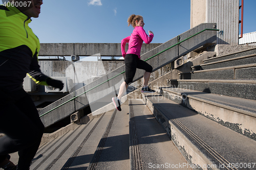 Image of young  couple jogging on steps