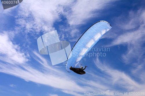 Image of Paragliding on background of blue summer sky and white clouds