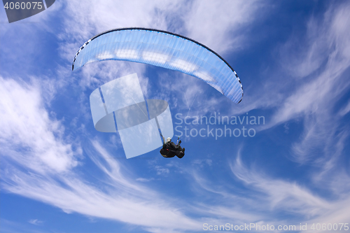 Image of Paragliding on background of blue summer sky and white clouds